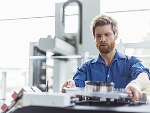 Worker organising spare parts in factory