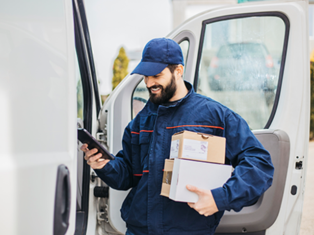 Delivery driver holding multiple boxes