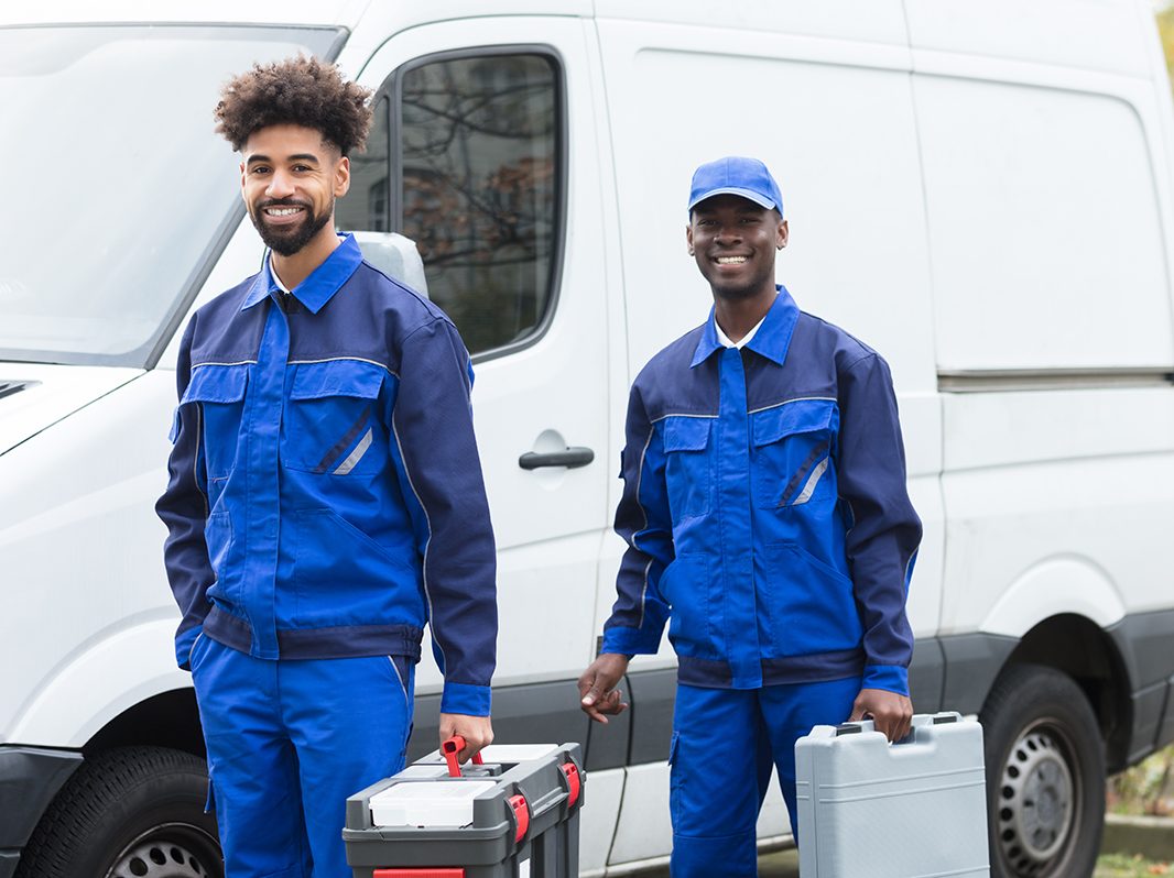 Portrait Of Two Young Manual Worker With Their Tool Boxes